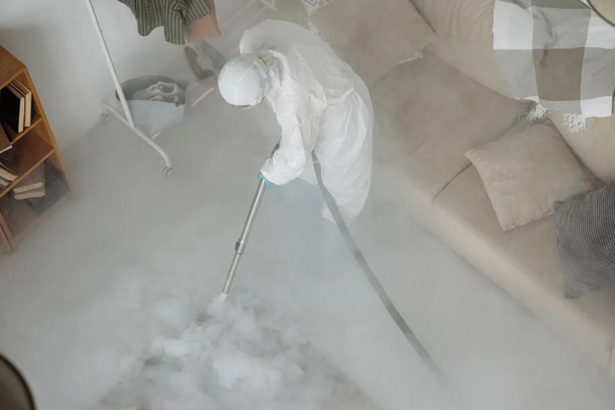 Biohazard cleanup technician in protective equipment, Fulton, TX